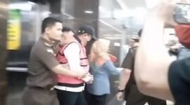 Mantan Pj Gubernur Sulsel, Bahtiar Baharuddin, digiring penyidik Kejati Sulsel dengan mengenakan rompi tahanan merah dan topi usai ditetapkan sebagai tersangka dalam kasus dugaan korupsi pengadaan bibit nanas.