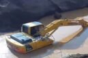 Excavator sedang mengeruk atau memindahkan material dari dasar genangan Milik H Ruppa